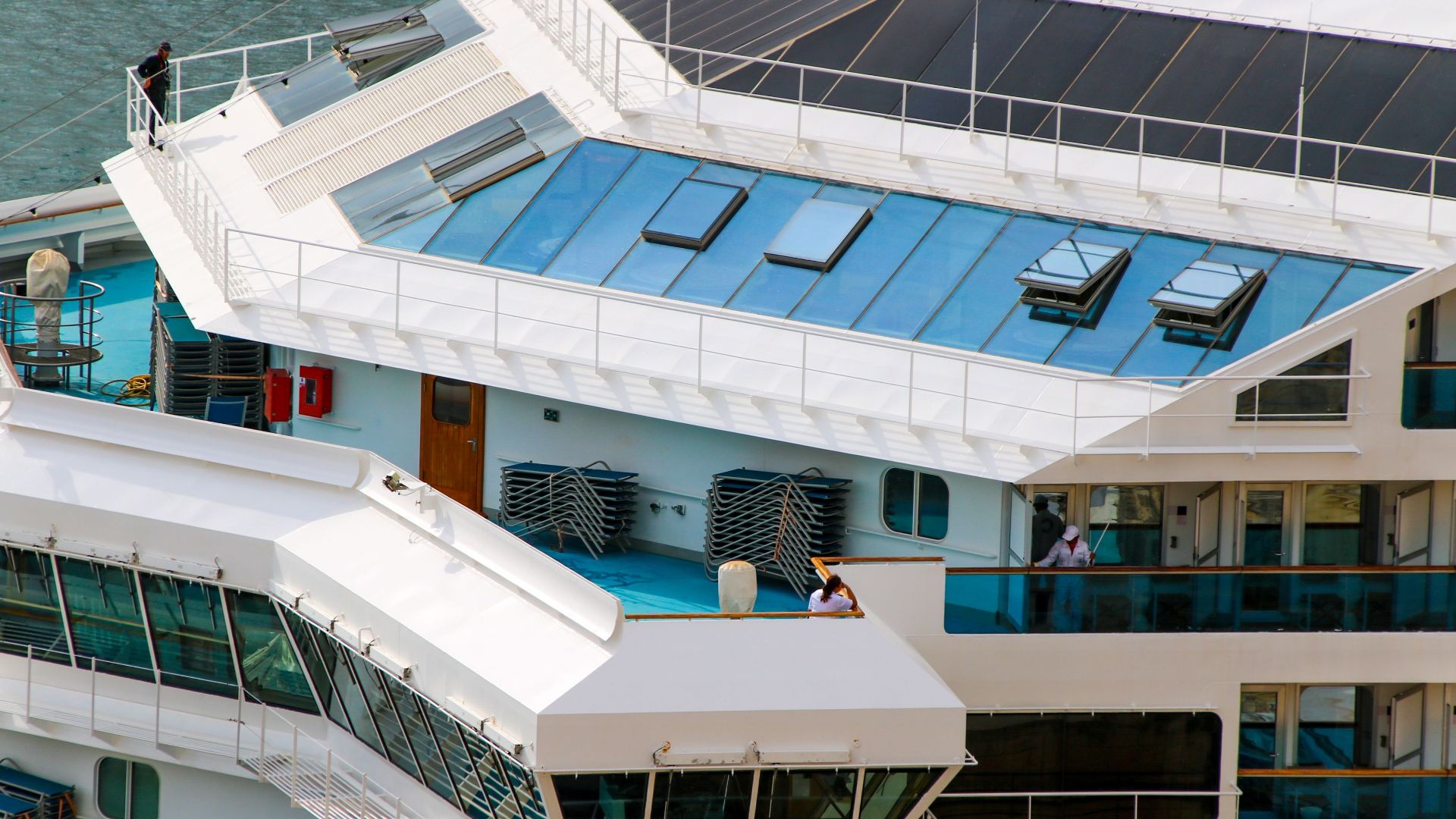 Close-up aerial view of a cruise ship deck highlighting modern design elements.