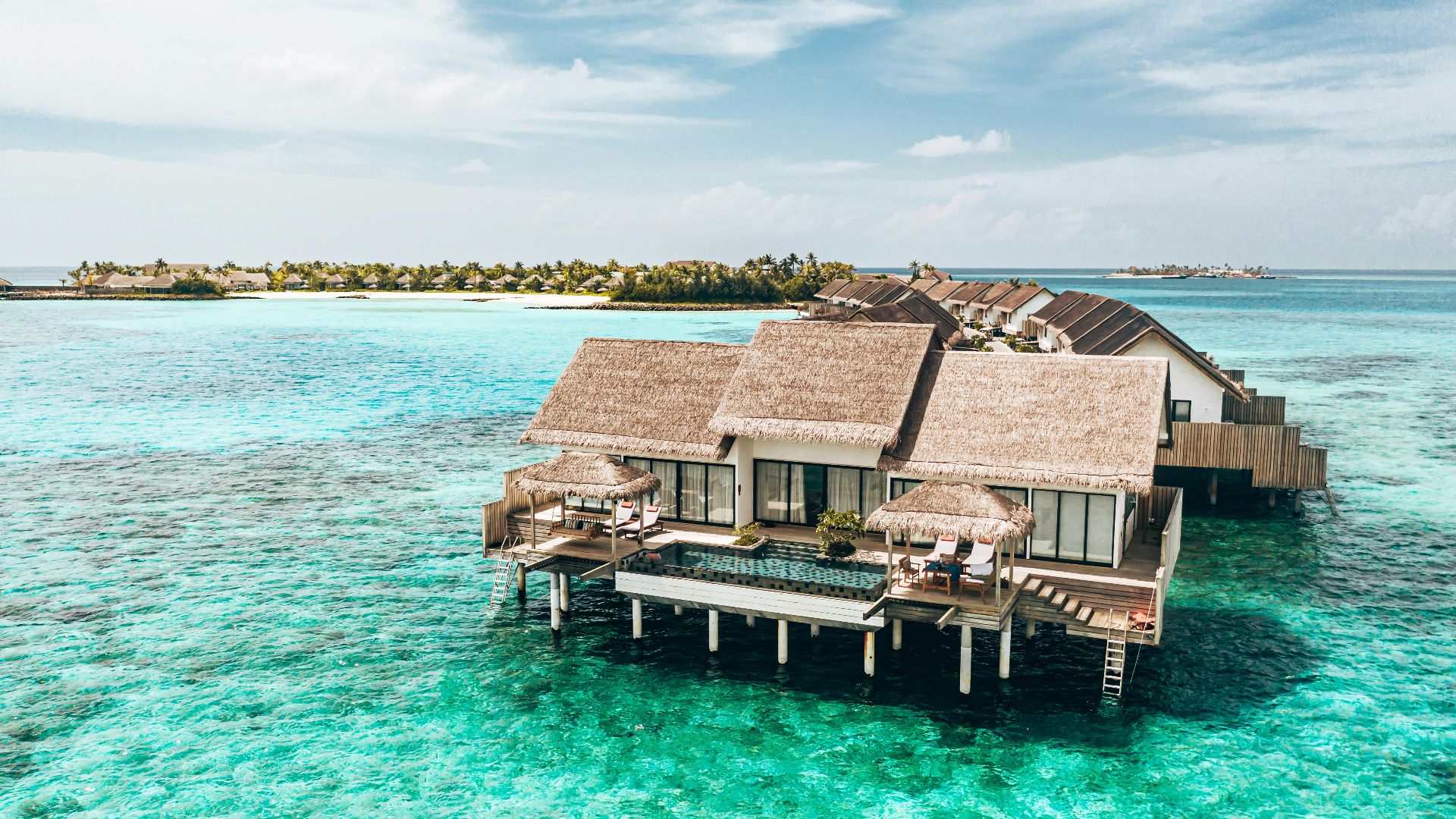 a couple of houses sitting on top of a body of water