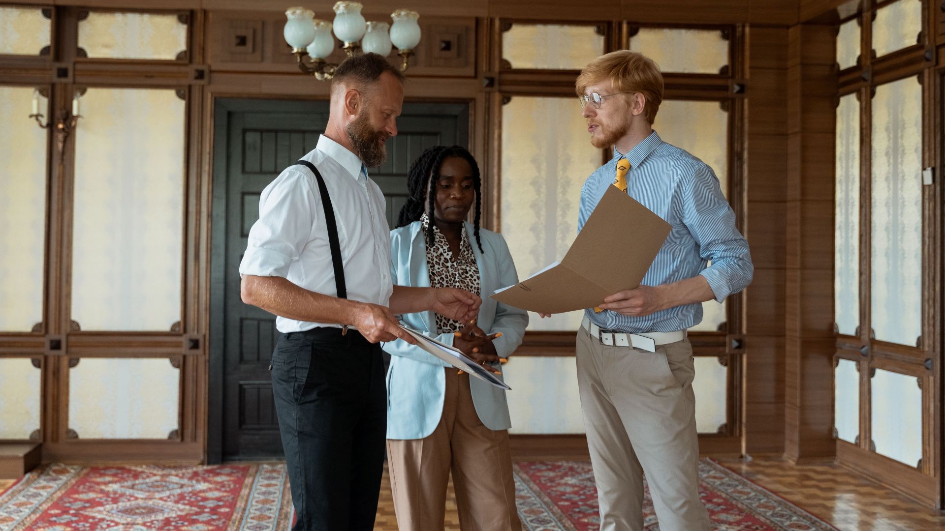 Three business professionals engaged in a discussion in a vintage office setting, showcasing teamwork and collaboration.
