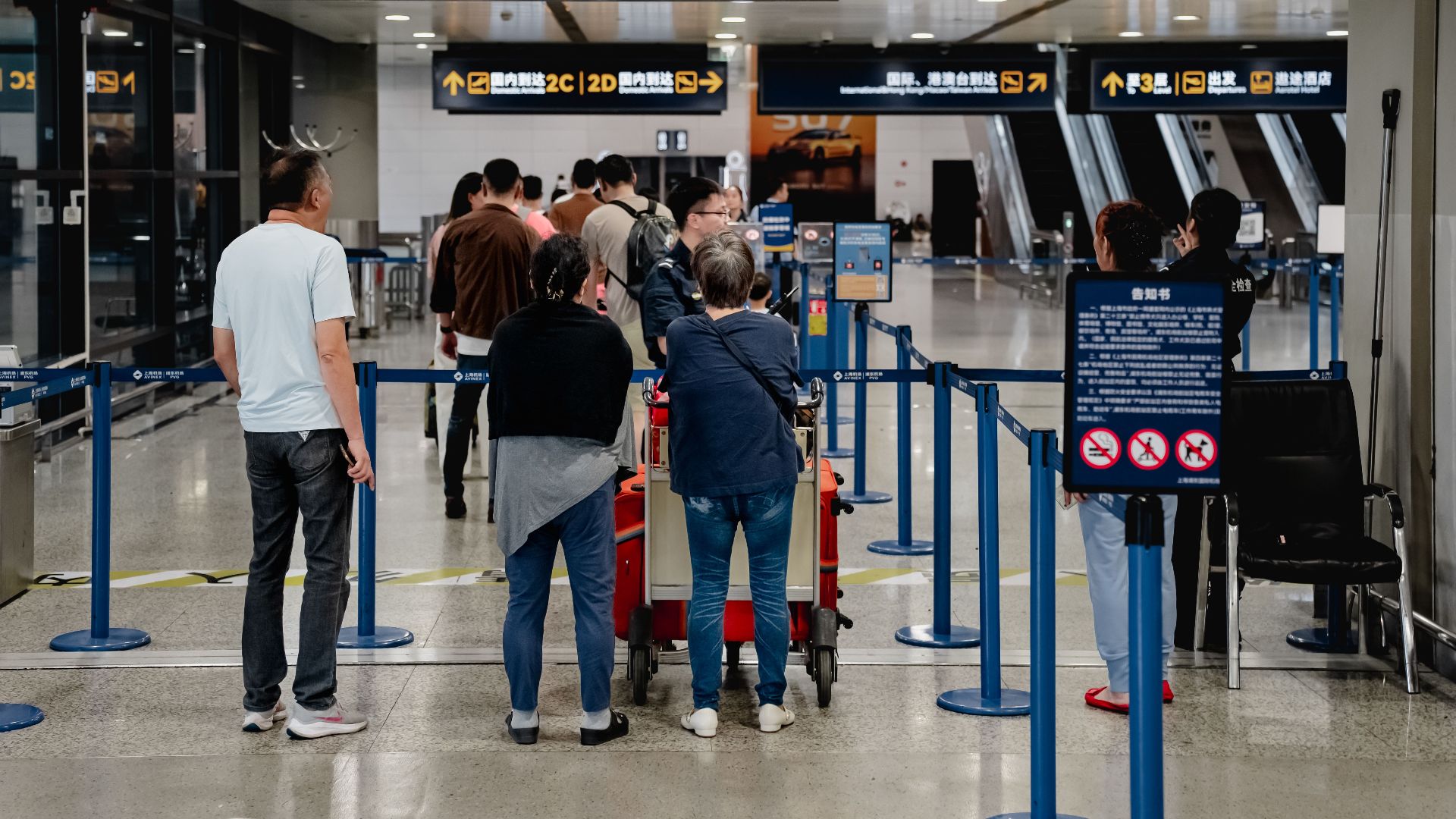 Passengers queue at Terminal 2 in Shanghai Airport, China.