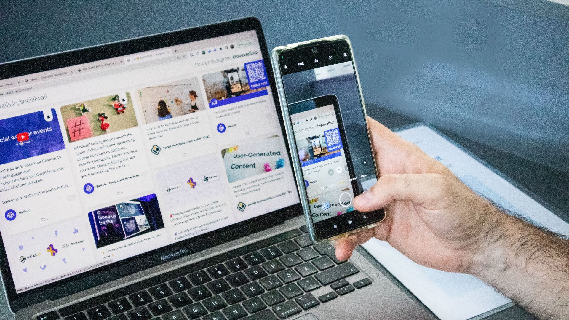 Close-up of a smartphone capturing a laptop screen, representing technology integration.