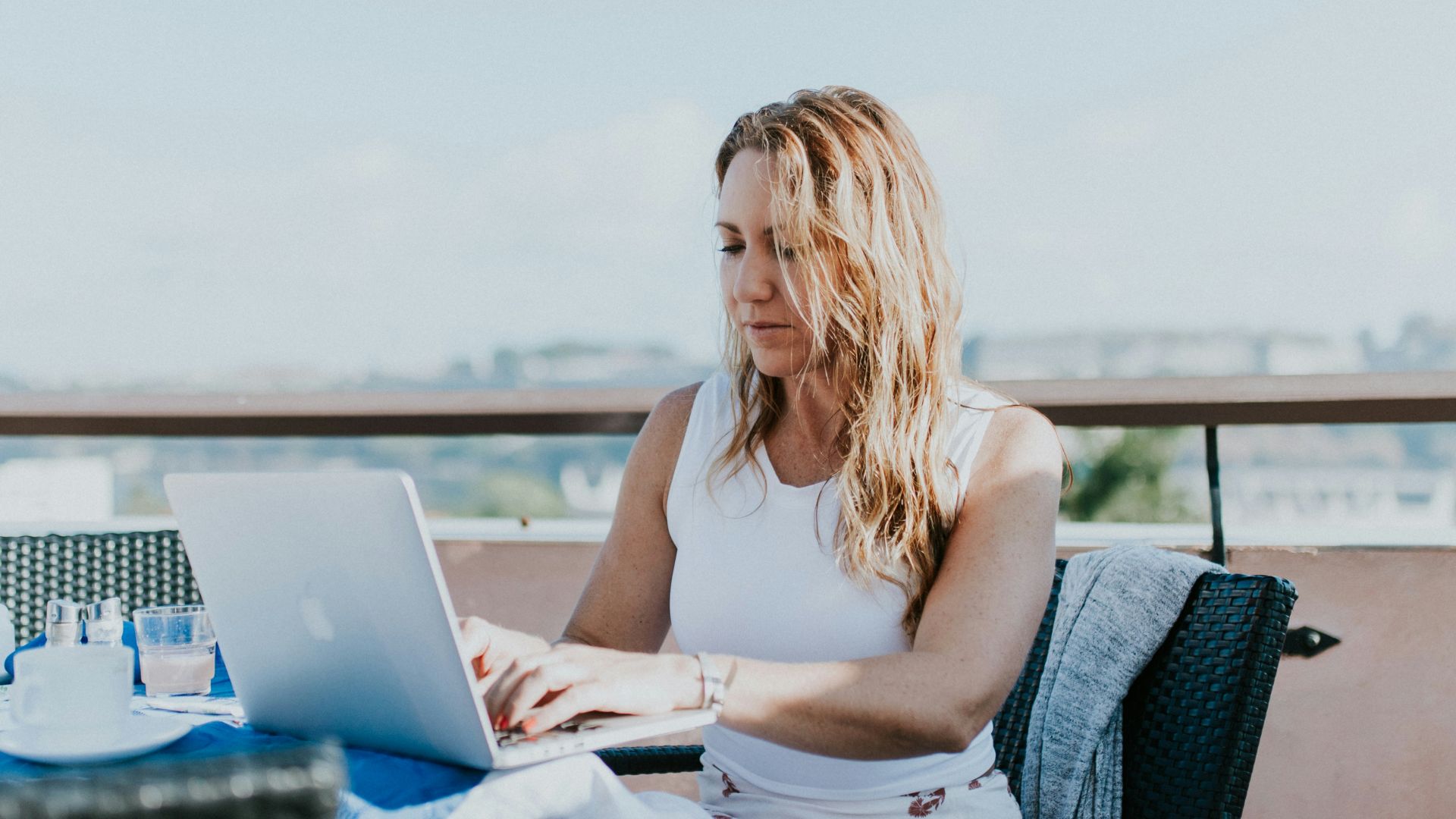 woman sitting on chair while using MacBook