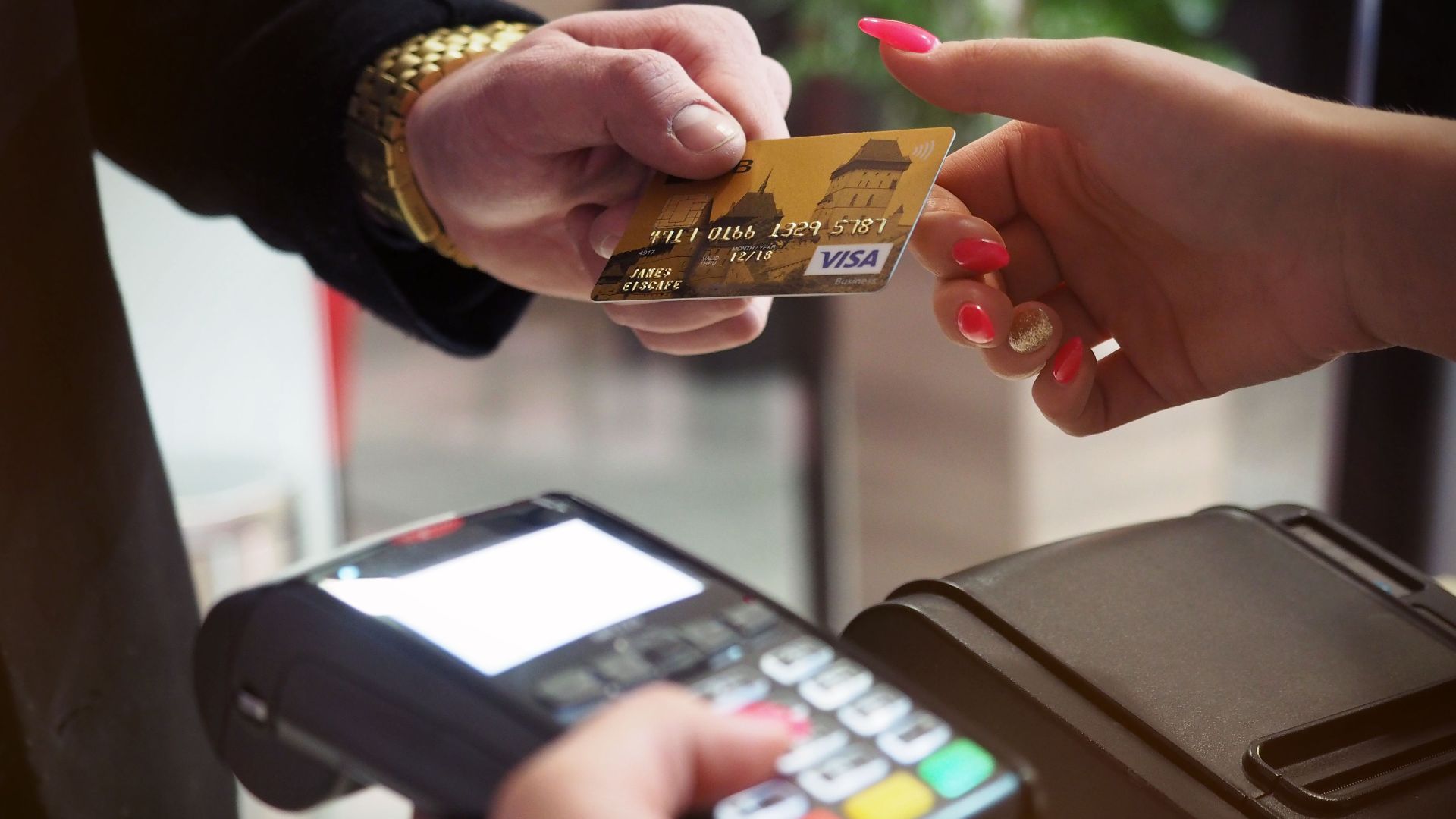 Close-up of a credit card payment being processed at a POS terminal.