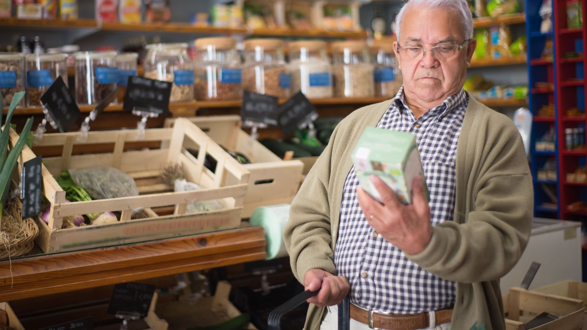 Senior man inspecting a product in a traditional Portuguese market.