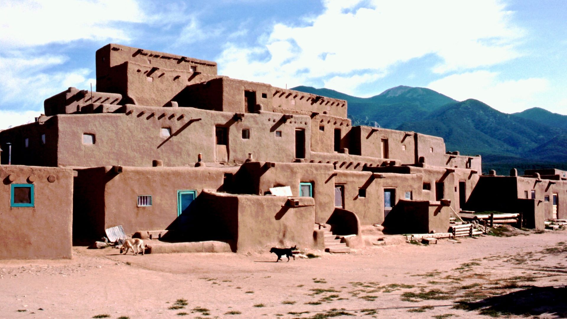Taos Pueblo (or Pueblo de Taos) is an ancient pueblo belonging to a Taos-speaking (Tiwa) Native American tribe of Puebloan people. It lies about 1 mile (1.6 km) north of the modern city of Taos, New Mexico, USA. The pueblos are considered to be one of the