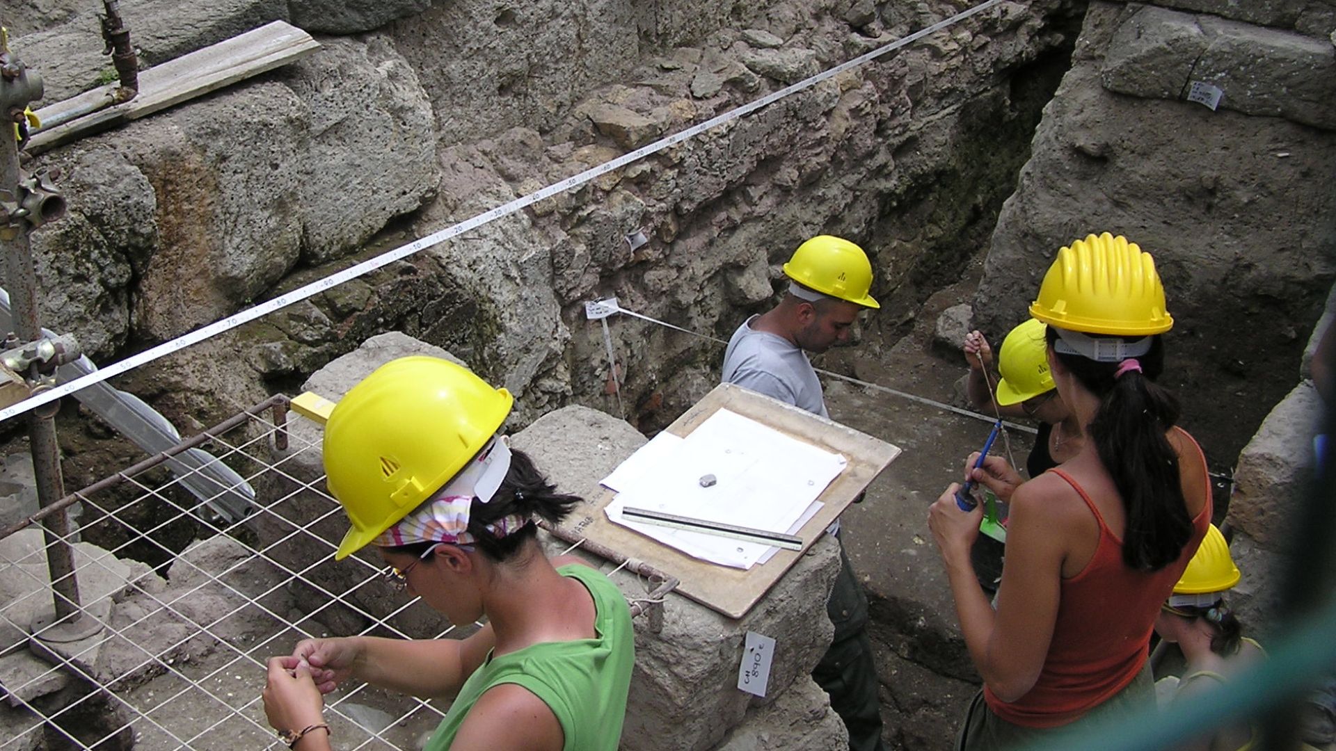 Excavations at the Roman Forum in Rome, Italy, are being mapped by these archaeologists. 

Photographed by myself (Adrian Pingstone) in June 2007 and placed in the public domain.