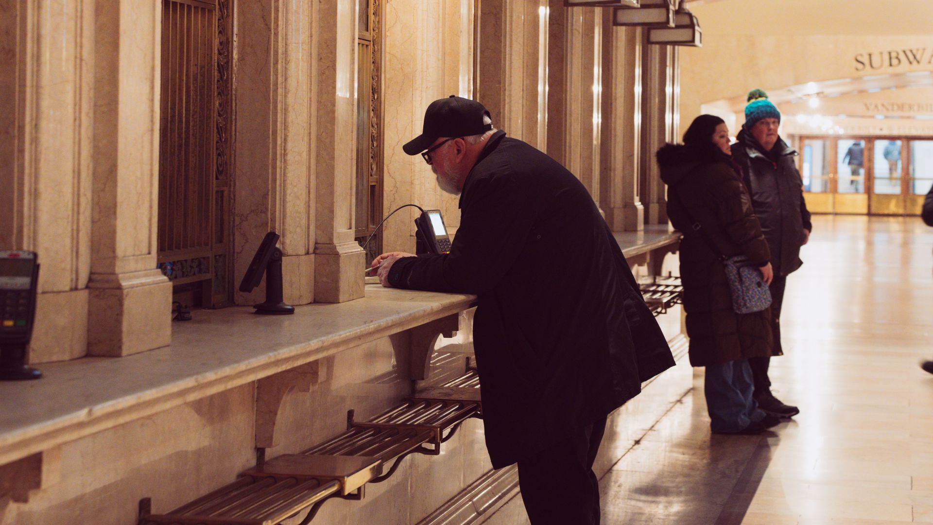 People at a vintage ticket counter in Grand Central Terminal, New York City.