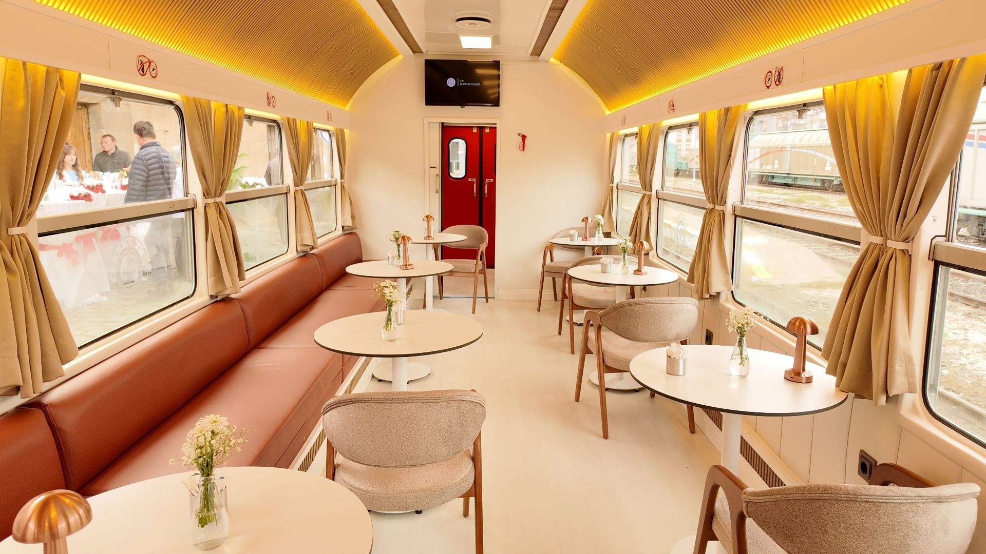 Elegant dining car interior with tables and soft lighting in a train in Burdur, Türkiye.