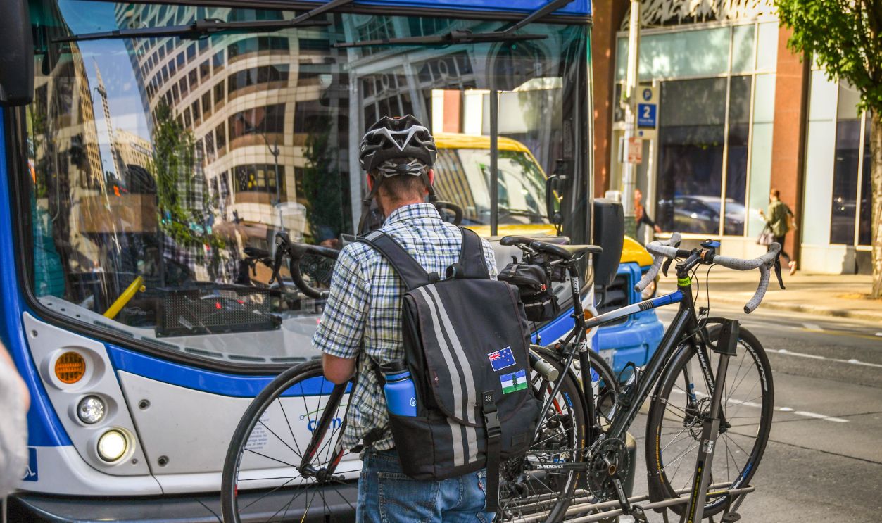 SEATTLE, WA, USA, - JUNE 2018: Person attaching his bike to the bike rack on the front of a local public service bus in downtown Seattle.