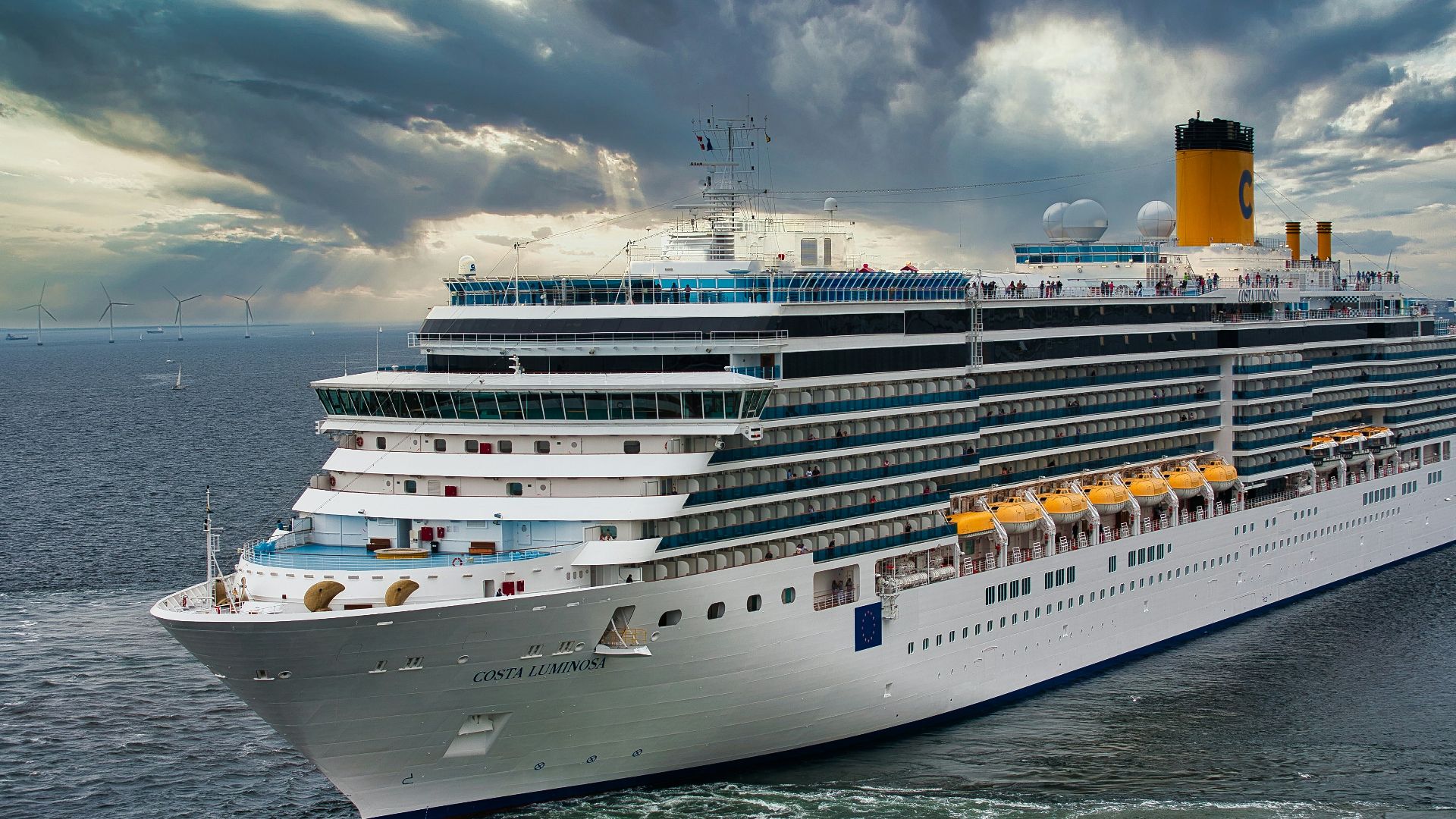 white cruise ship on sea under white clouds and blue sky during daytime