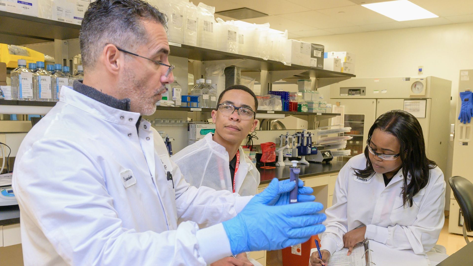a group of people in a lab looking at something