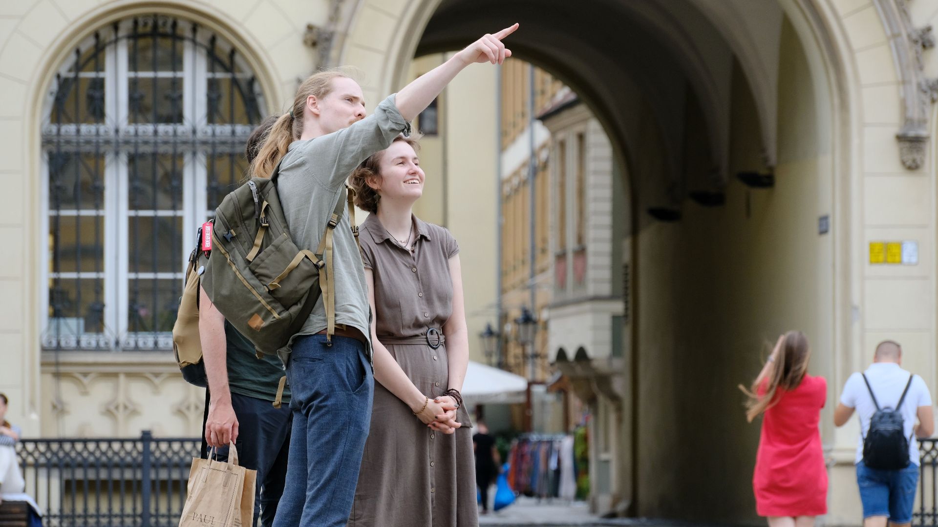 Group of travelers exploring a historic city landmark with enthusiasm and curiosity.