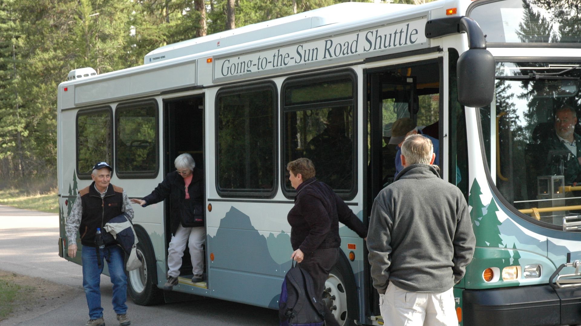 Visitors geting off a shuttle bus for Glacier's Centennial celebration. Photo: Mark Wagner, NPS