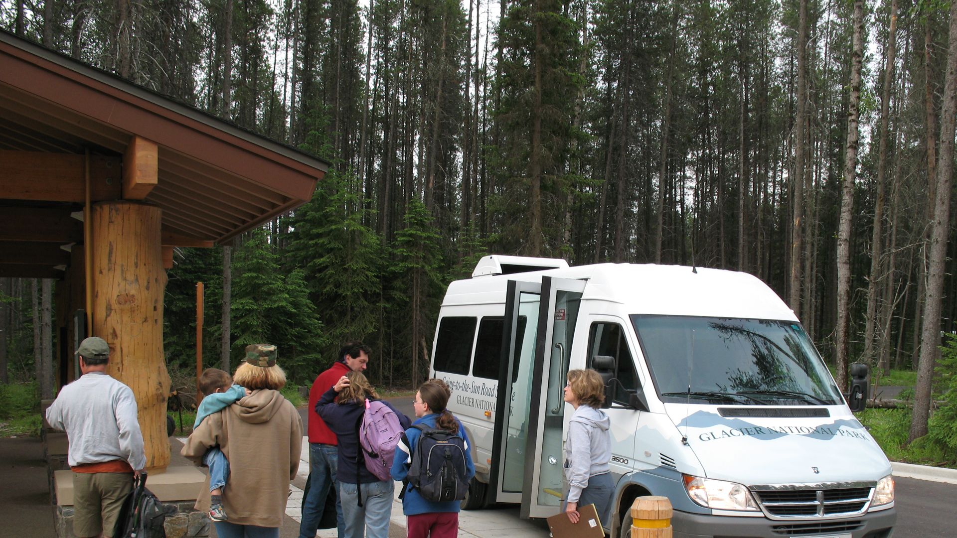 Visitors boarding a shuttle bus.