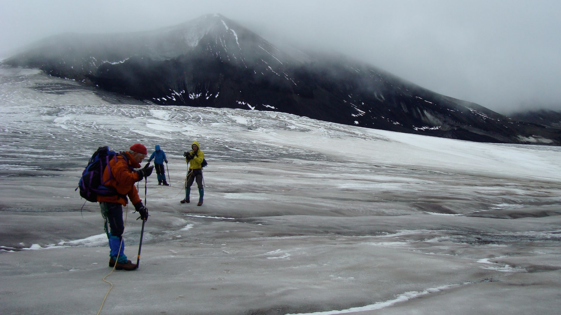 Climbing the glacier of Mount Edziza with Tennena Cone in the background