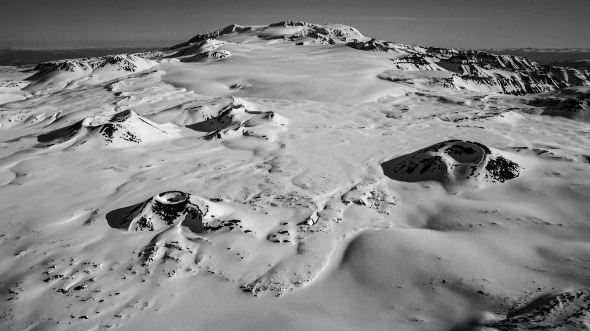 Mount Edziza from the south. Coffee Crater is at left center, Techno Glacier is at center and Ice Peak (the remains of another ancient volcano in the Mount Edziza Volcanic Complex) at upper right center.  Edziza itself is at upper center, the southern rim
