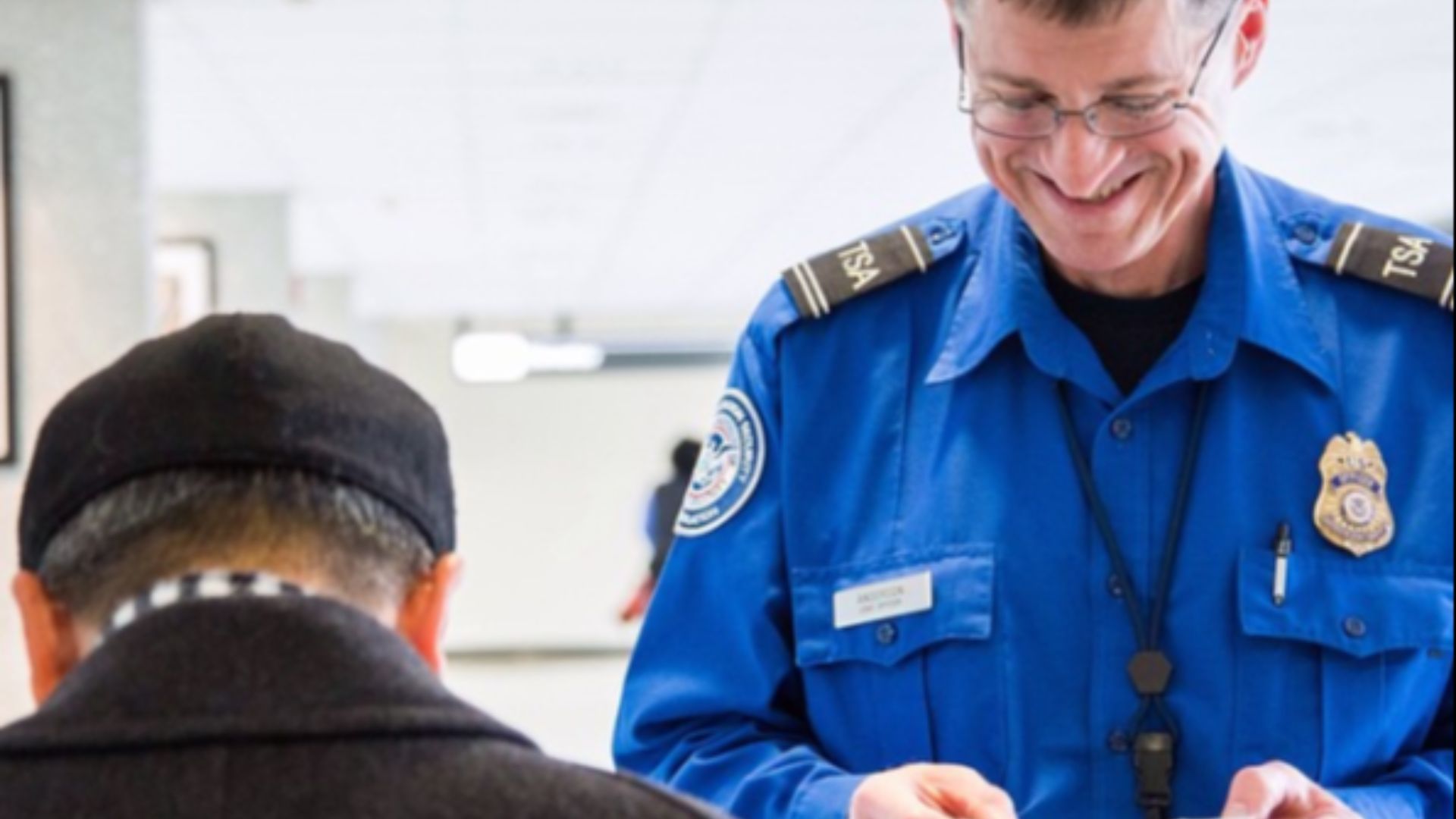 TSA officer checking a passenger's ID