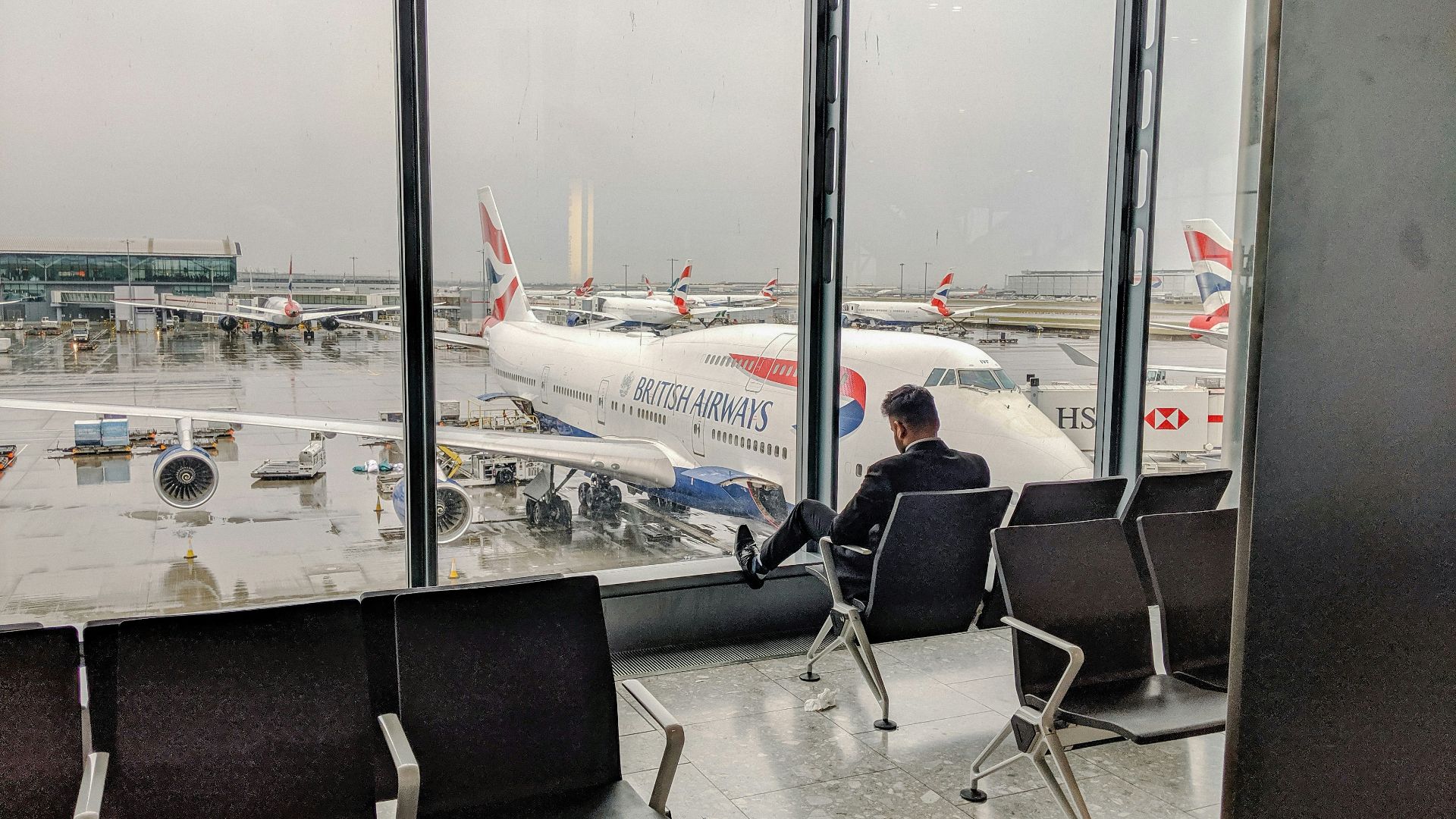 man in blue shirt sitting on black chair