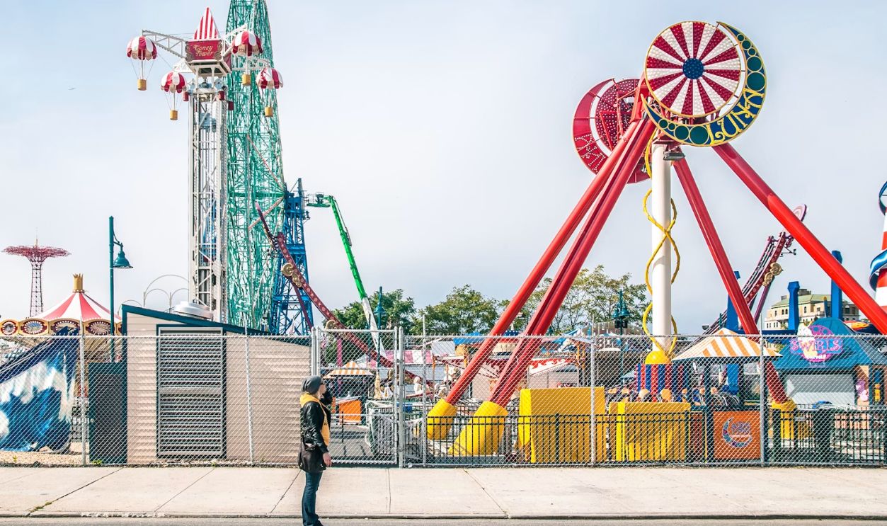 a person standing in front of a carnival ride