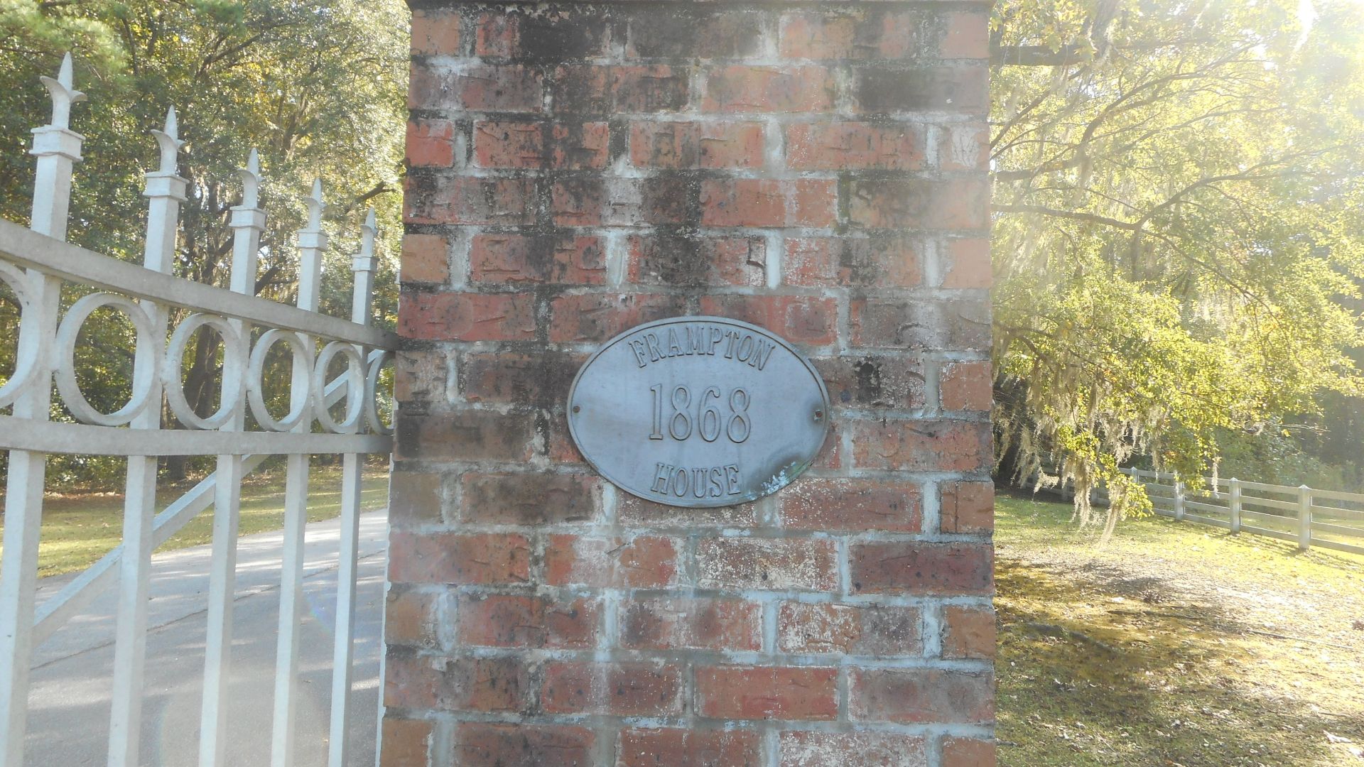 Plaque with the year of rebuilding on the right side of the gate to the driveway leading to the John Edward Frampton Plantation House, now occupied by the Lowcountry Visitor Center and Museum, on the southeast side of US 17 just east of Exit 33 off of I-9