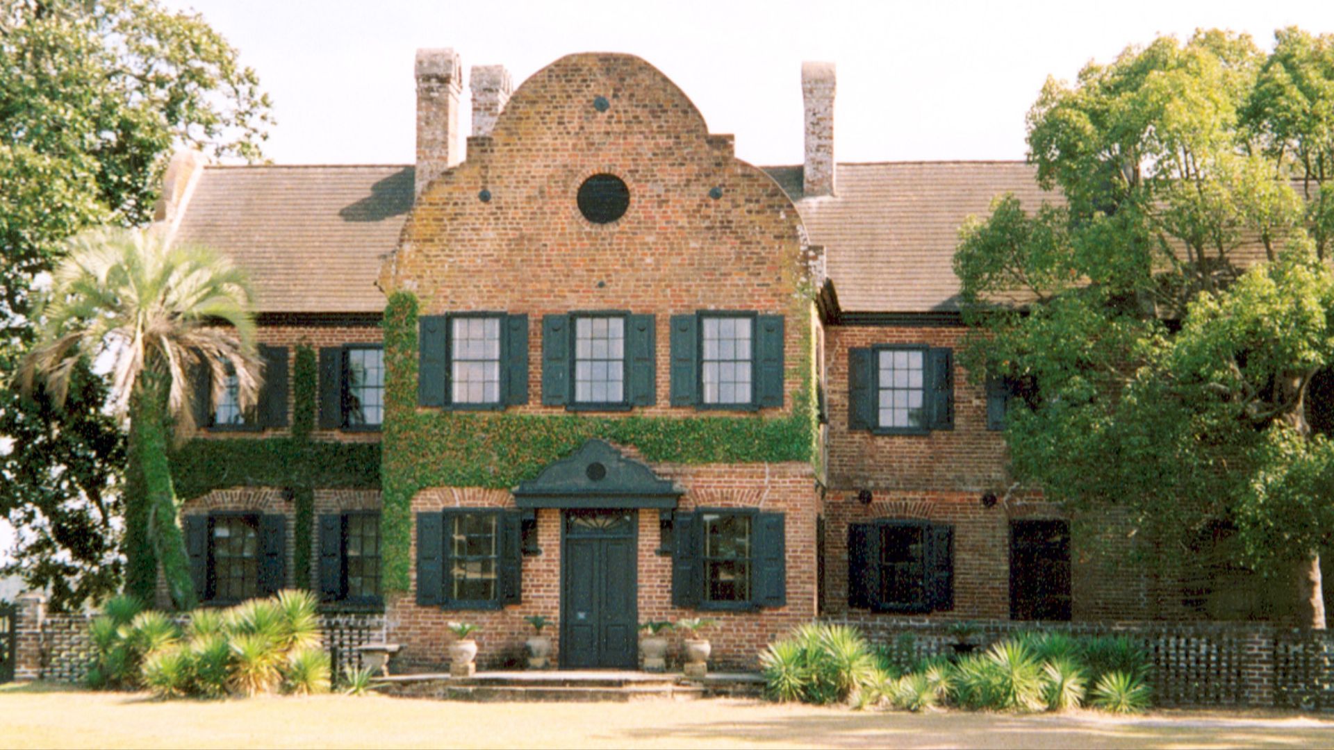 Scope and content:  The original finding aid described this photograph as:
Original Caption: The surviving south wing of the home faces the road, where visitors enter the grounds. The original front of the home faces the Ashley River, which visitors used 