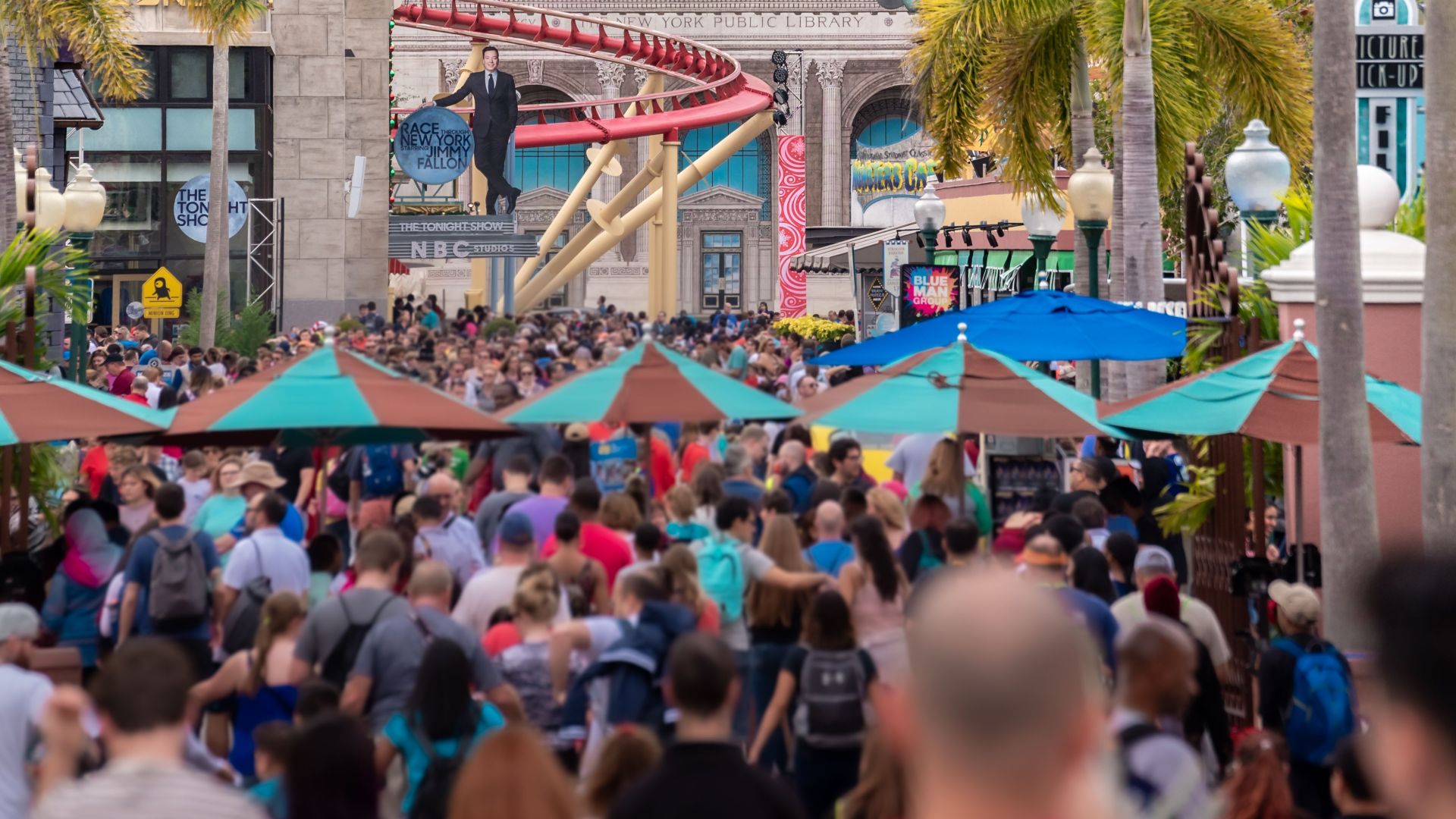 Vibrant scene with a large crowd at Universal Studios Orlando, capturing the lively theme park atmosphere.
