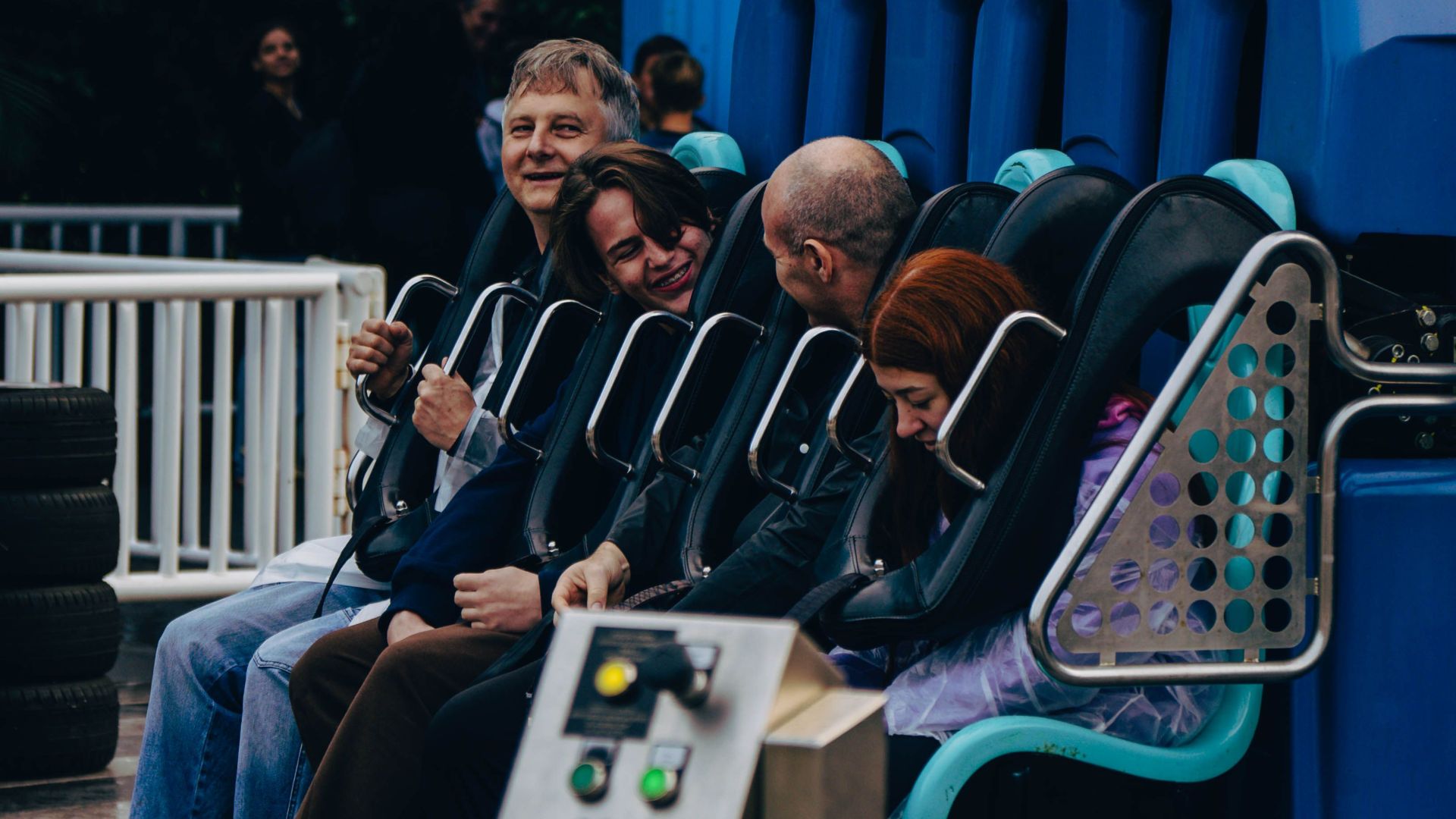 People having fun on a thrilling simulator ride at an amusement park.