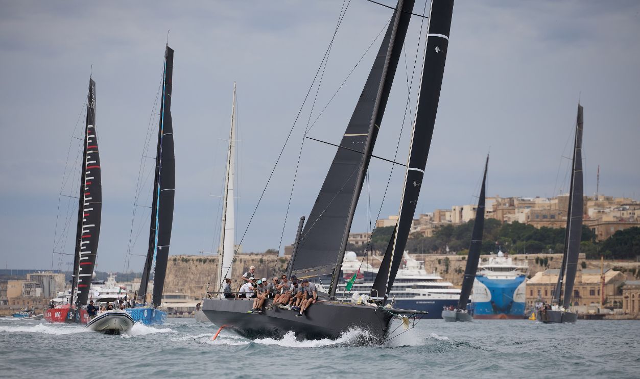 Participating racing yachts compete for the best positions before exiting the Malta Grand Harbour in Valletta, Malta, on October 18, 2025, soon after the start of the 46th Rolex Middle Sea Race.