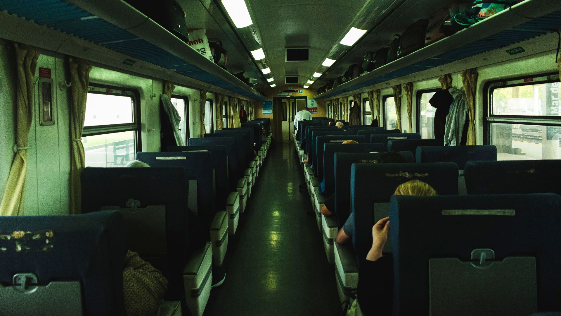 Passengers aboard a commuter train in Mar del Plata, Argentina, showcasing a typical travel scene.