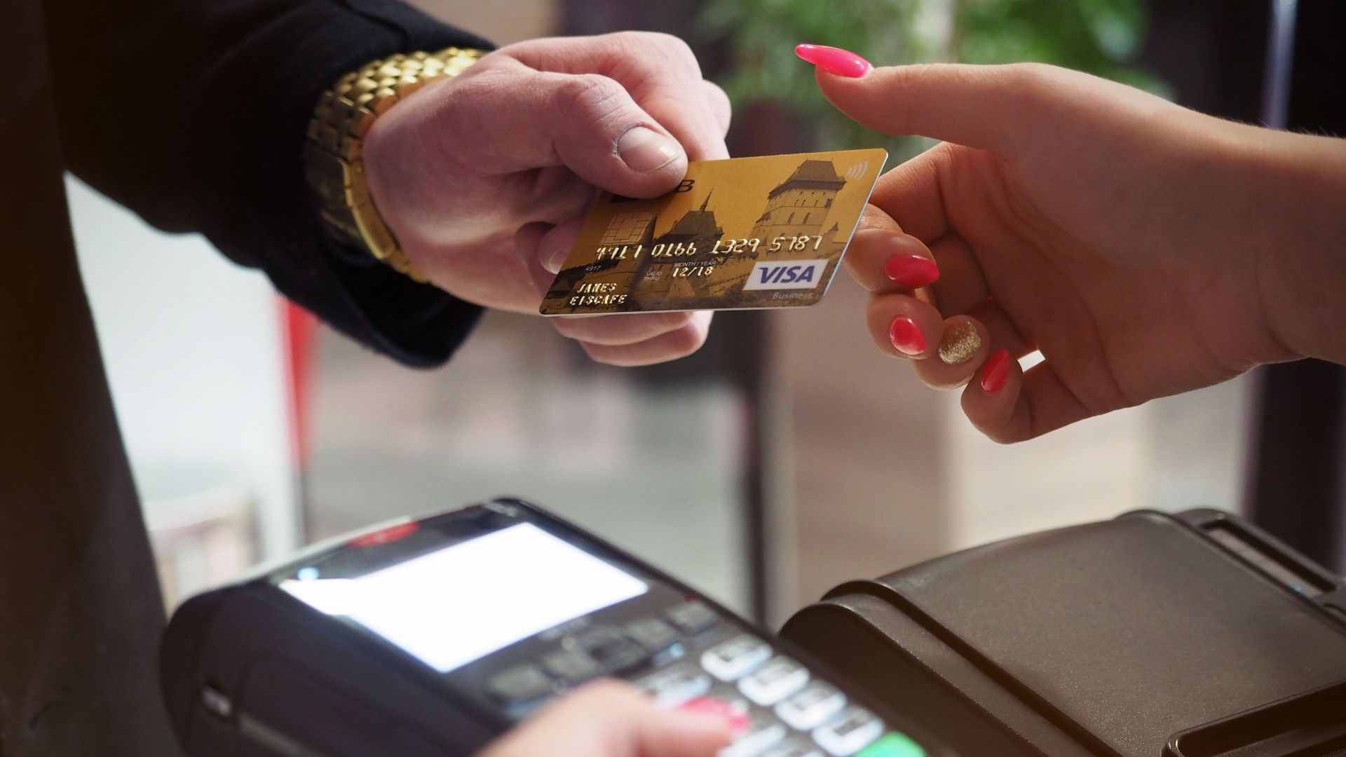Close-up of a credit card payment being processed at a POS terminal.