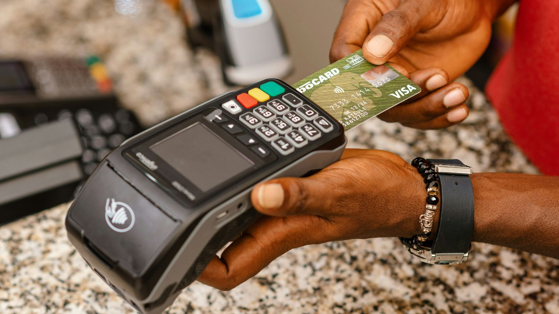 a person holding a credit card in their hand