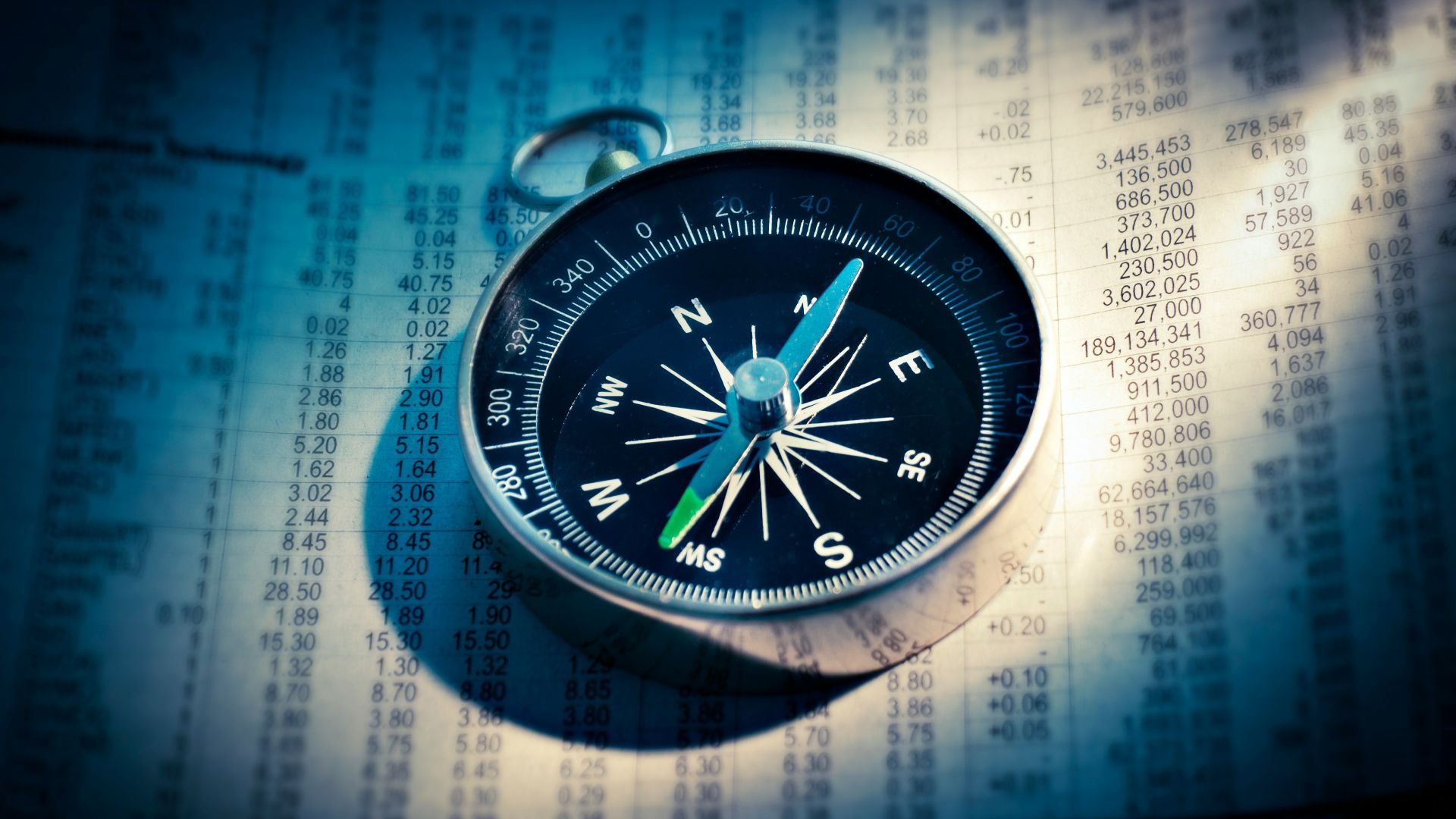 shallow focus photograph of black and gray compass