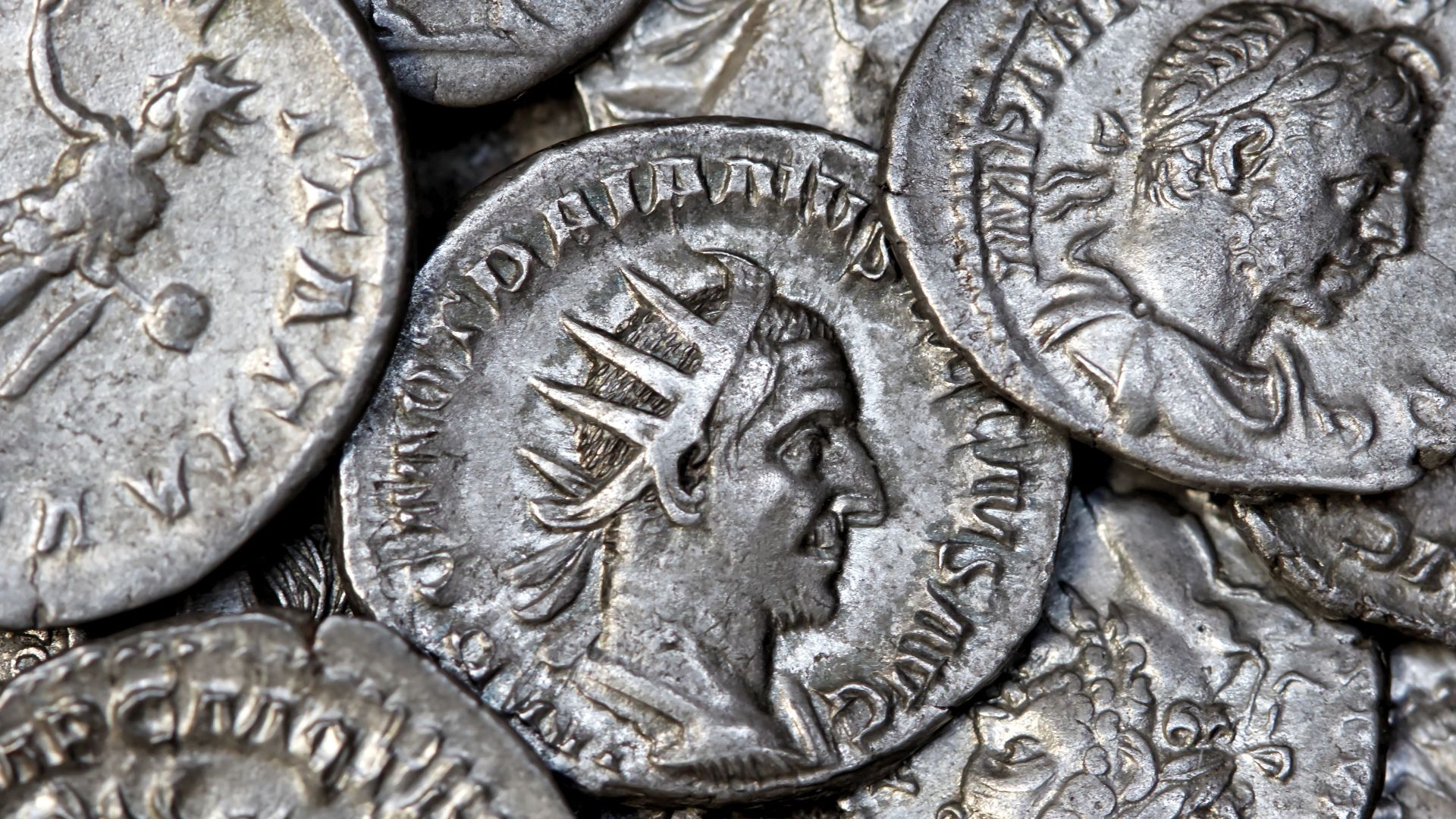 Close-up view of ancient Roman silver coins showcasing detailed engravings and historical significance.