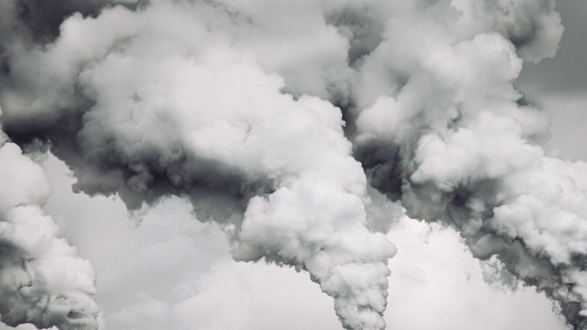 Smoke billows from factory chimneys in Konin, Poland, highlighting pollution and environmental impact.