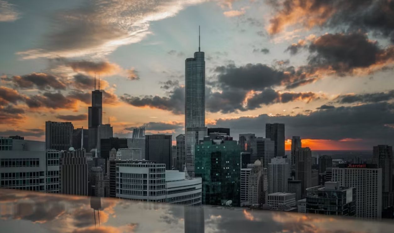 City skyline under a cloudy sky during sunset