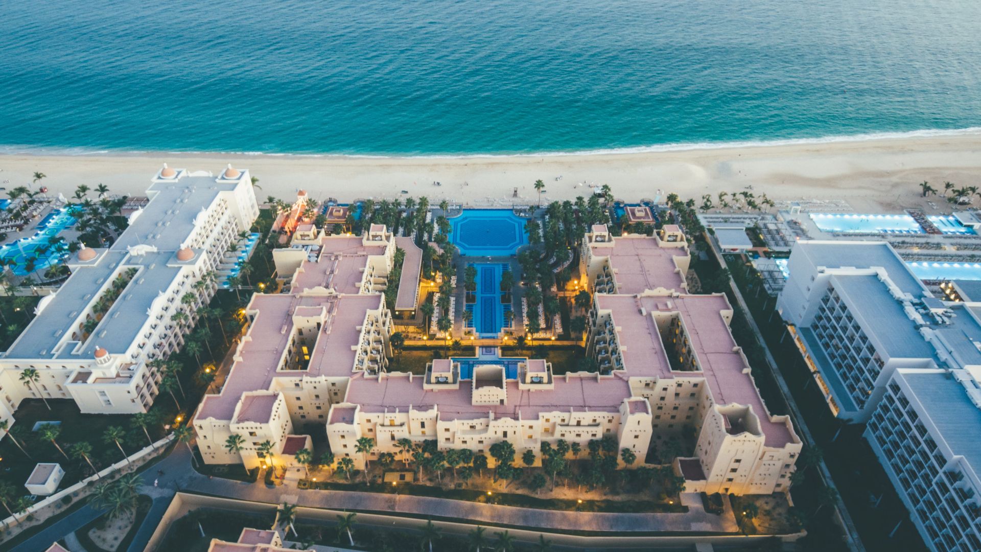 Stunning aerial shot of Cabo San Lucas beachfront resort showcasing architecture and ocean beauty.