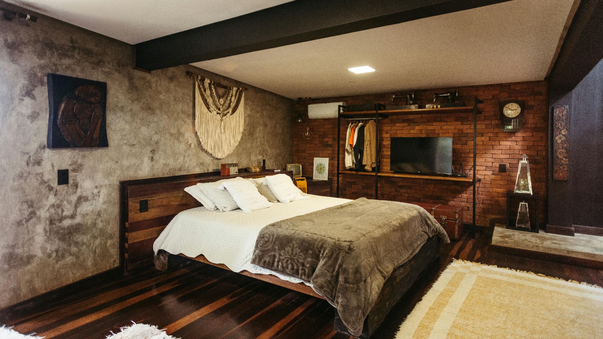 Stylish bedroom interior in Santa Teresa, Brazil featuring modern decor and warm tones.