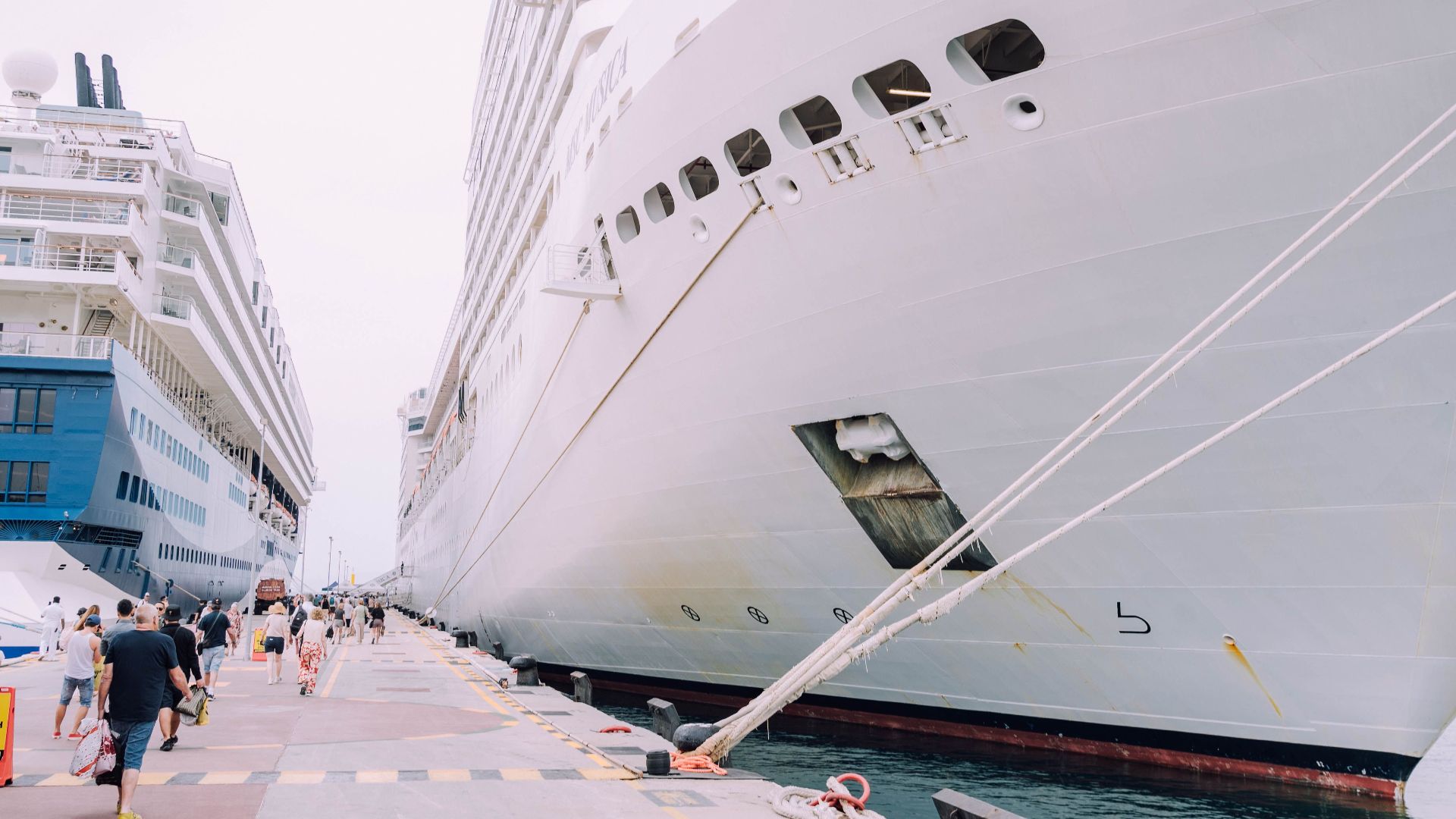 A pair of luxury cruise ships docked at a harbor, ready for leisure travelers.