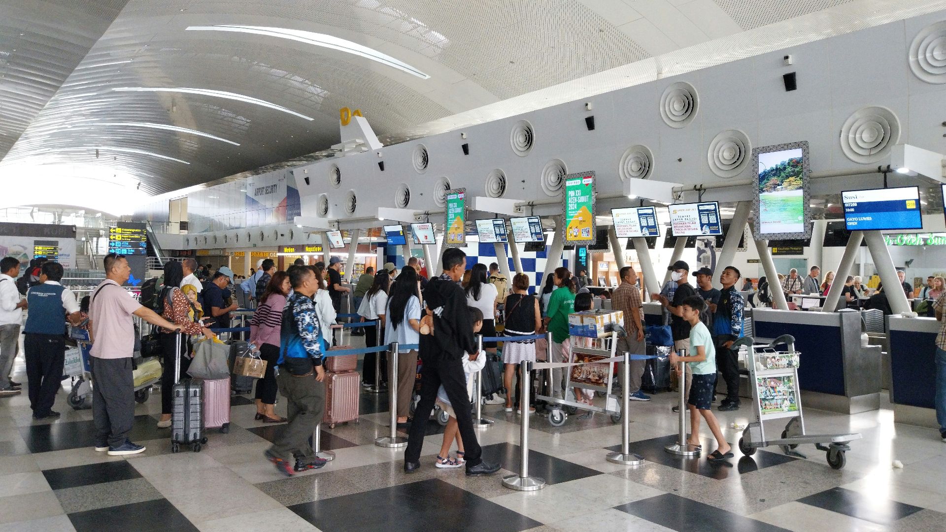 A large group of people waiting in line at an airport