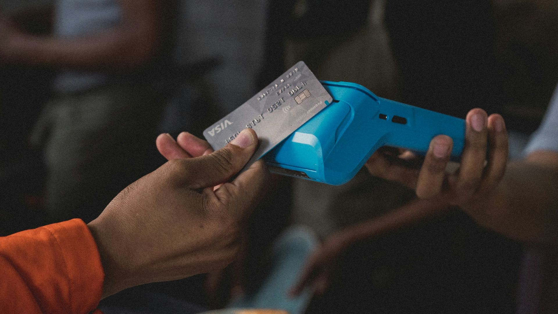 a person holding a blue object in their hand