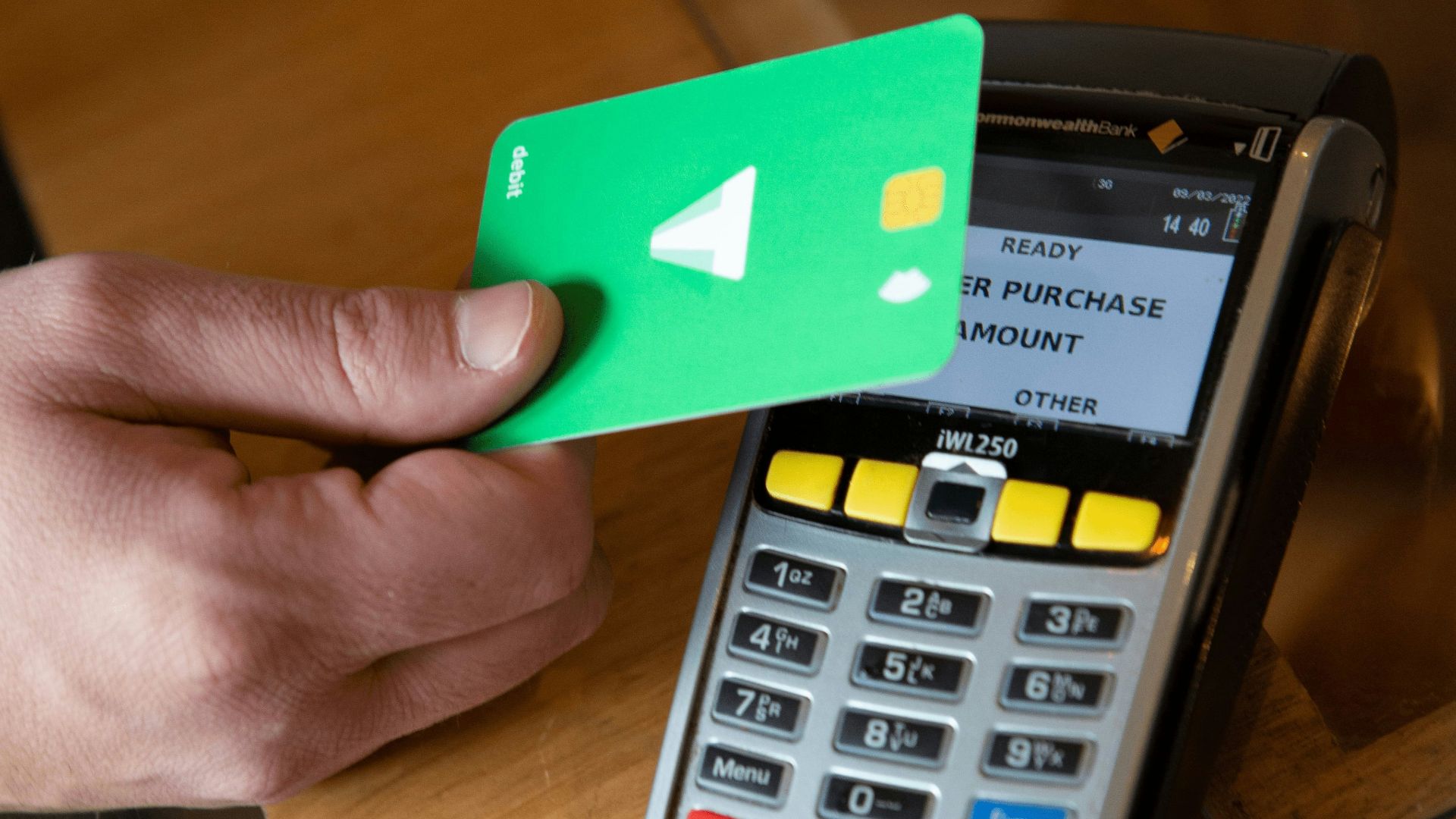 a person holding a credit card next to a calculator