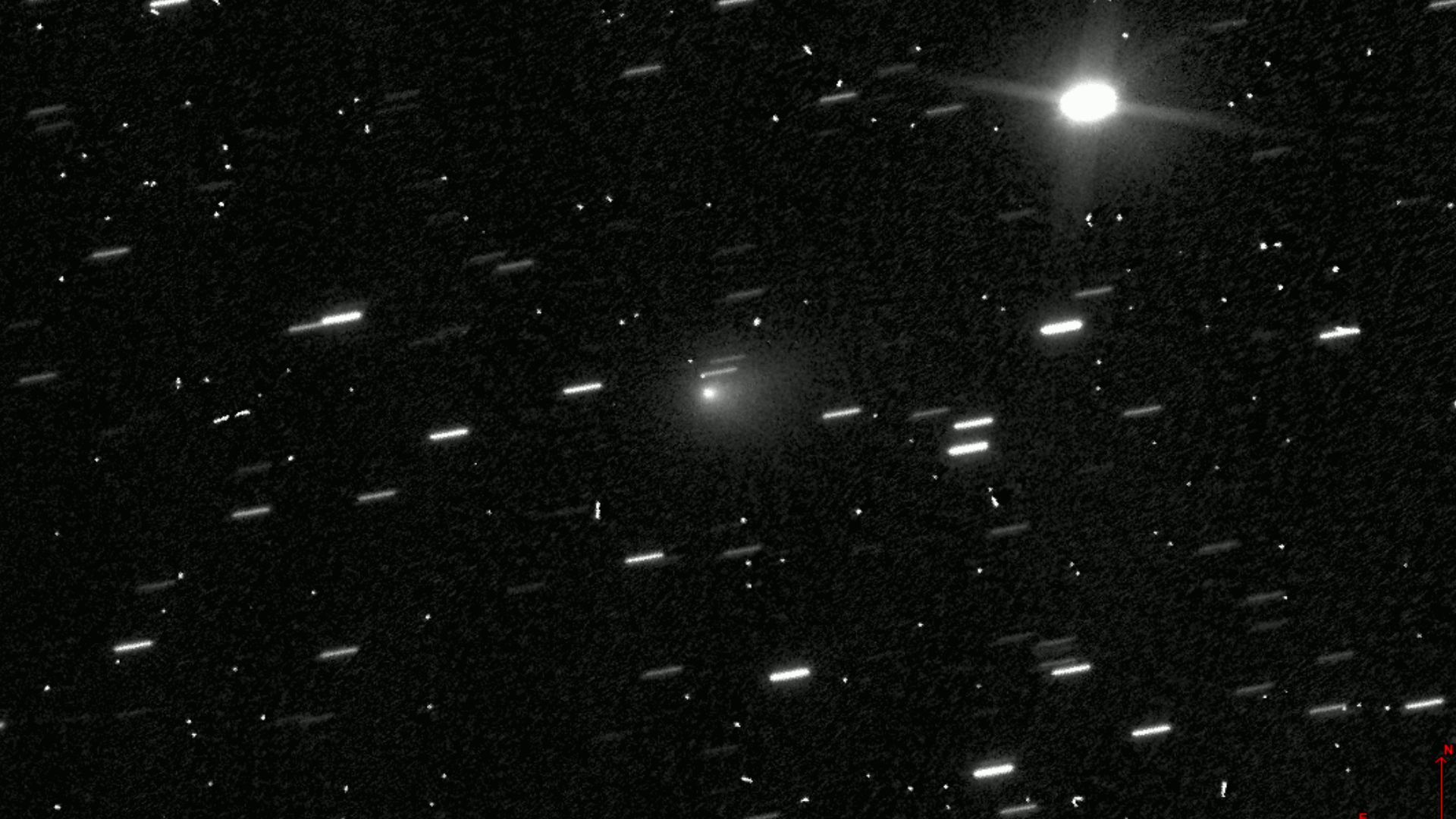 Two-frame animation of interstellar comet 3I/ATLAS (gray fuzzy blob, centered), seen moving across a field of stars in Hubble Space Telescope images taken on 21 July 2025 16:29 and 16:32 UTC. Each frame is a 40-second exposure taken with the WFC3 camera's
