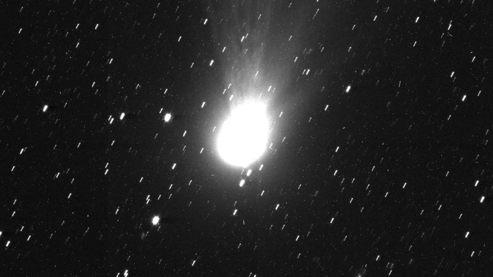 This striking image from the science camera on ESA’s Jupiter Icy Moons Explorer (Juice) shows interstellar comet 3I/ATLAS spewing dust and gas. The tiny nucleus of the comet (not visible) is surrounded by a bright halo of gas known as the coma. A long tai