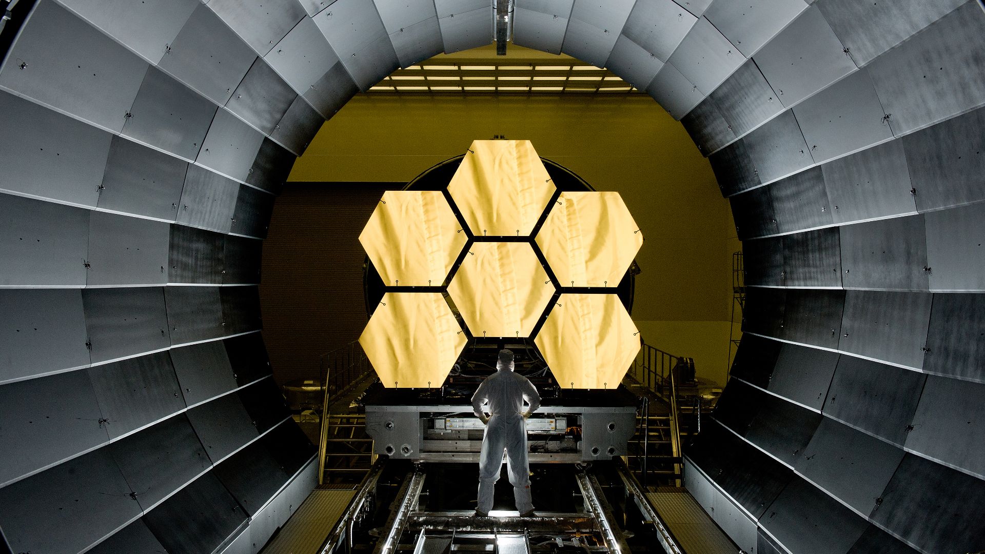 NASA engineer Ernie Wright looks on as the first six flight ready James Webb Space Telescope's primary mirror segments are prepped to begin final cryogenic testing at NASA's Marshall Space Flight Center.