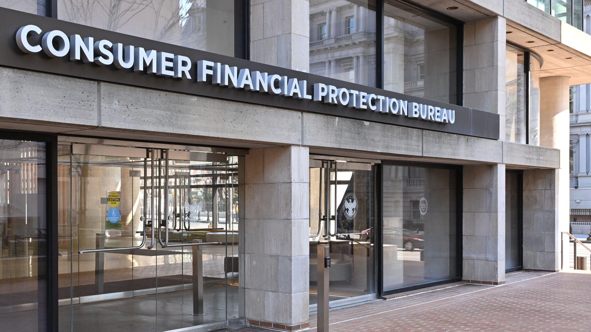 The entrance to the Consumer Financial Protection Bureau headquarters with the bureau's name above it. 1700 G Street NW, Washington, DC 20552.
