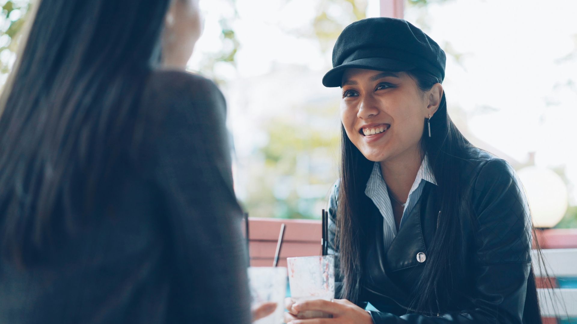 Two women talking at an outdoor cafe