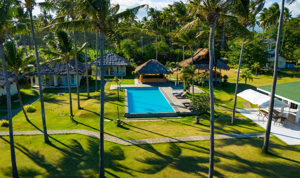 Stunning aerial view of a tropical resort with a pool and lush greenery in Bacong, Central Visayas