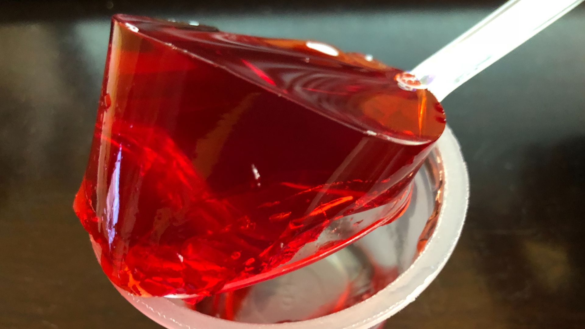 Gelatin from a single opened cup of Jell-O strawberry gelatin snack being lifted by a spoon in the Franklin Farm section of Oak Hill, Fairfax County, Virginia