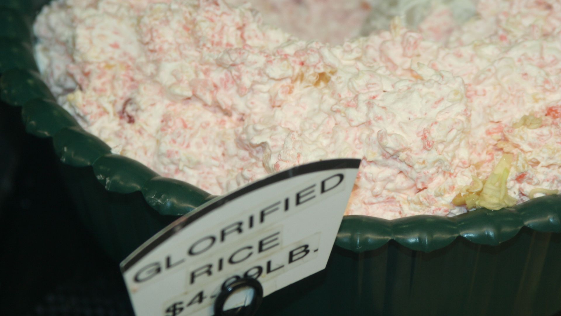 Glorified rice from a supermarket in the land of ice and snow (Minnesota). Recipe includes rice, crushed pineapple, egg, sugar, vinegar, flour and whipped cream with maraschino cherries as a decoration (or as in this case mixed in for color). As a courtes