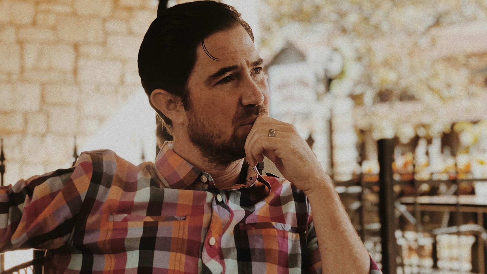 man in red and black plaid dress shirt